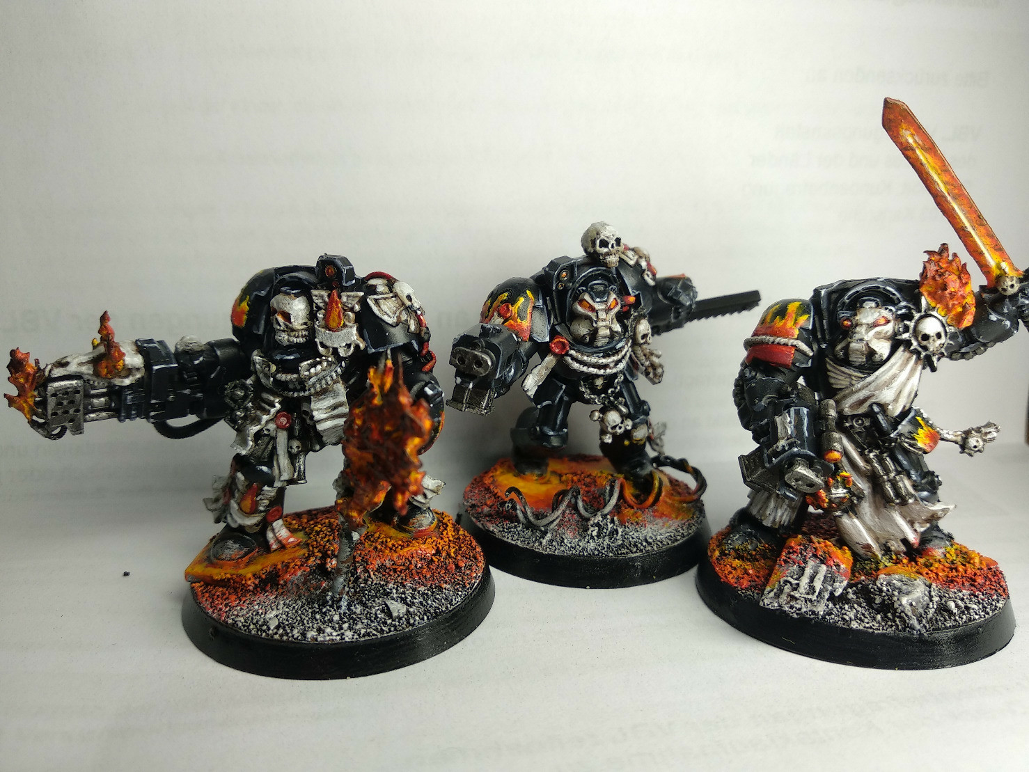 photo of 3 painted Warhammer miniatures, black terminators with flames and bones