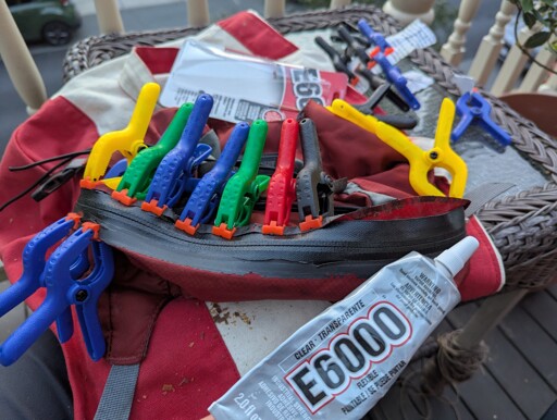Reattached zipper on backpacking pack pouch with E6000 and mini clamps